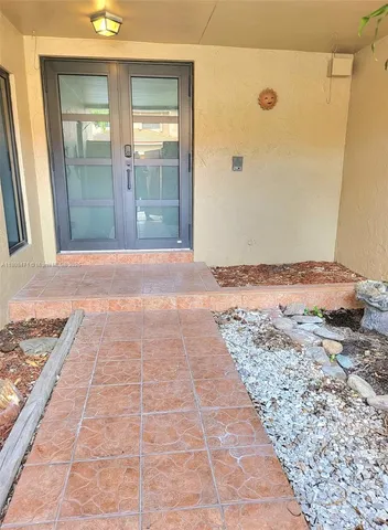 a view of kitchen with a sink and a refrigerator