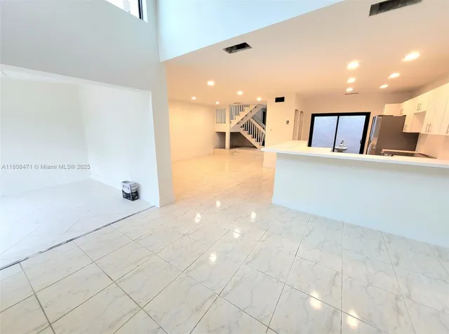 a view of empty room with stairs