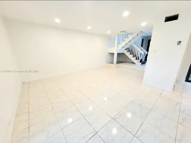 a view of a livingroom with wooden floor and a fireplace