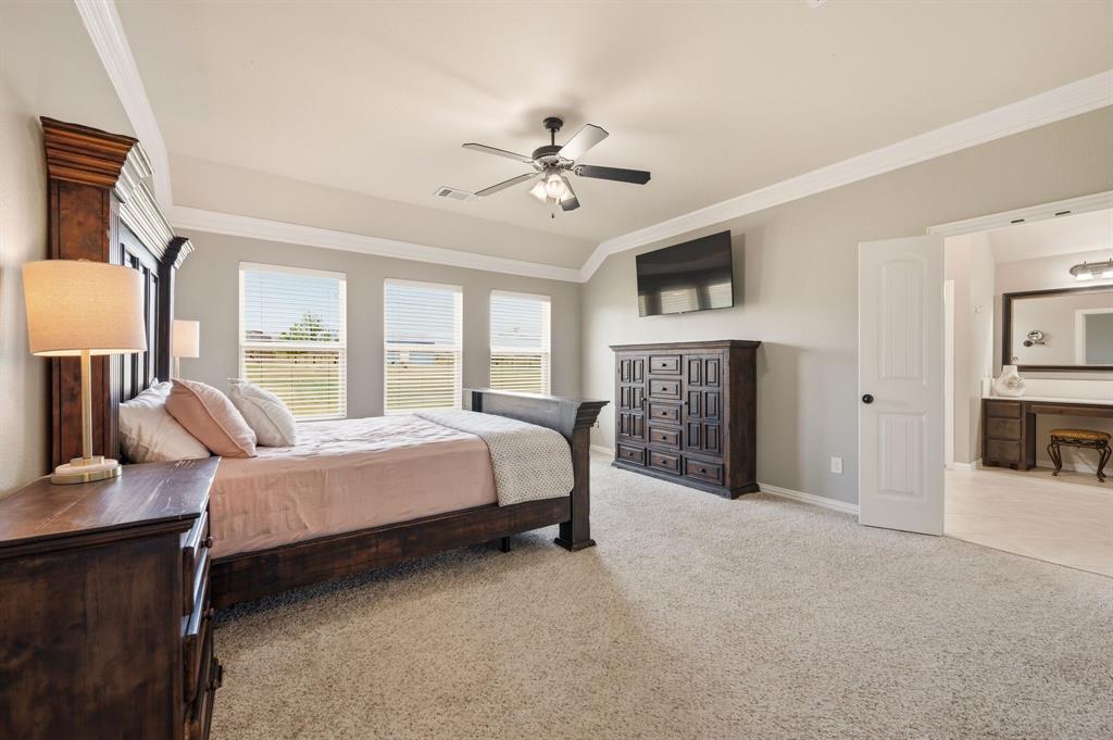 140 Heather Lane Decatur, TX 76234 - Photo 21 of 39 a bed room with a bed and a ceiling fan
