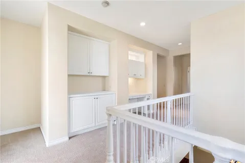 a view of a hallway with a closet and wooden floor
