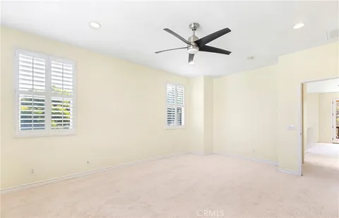 a view of a big room with wooden floor and windows