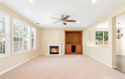 a view of an empty room with a fireplace and a window