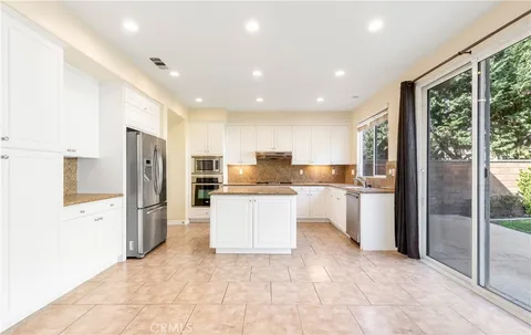 a kitchen with a refrigerator and a sink