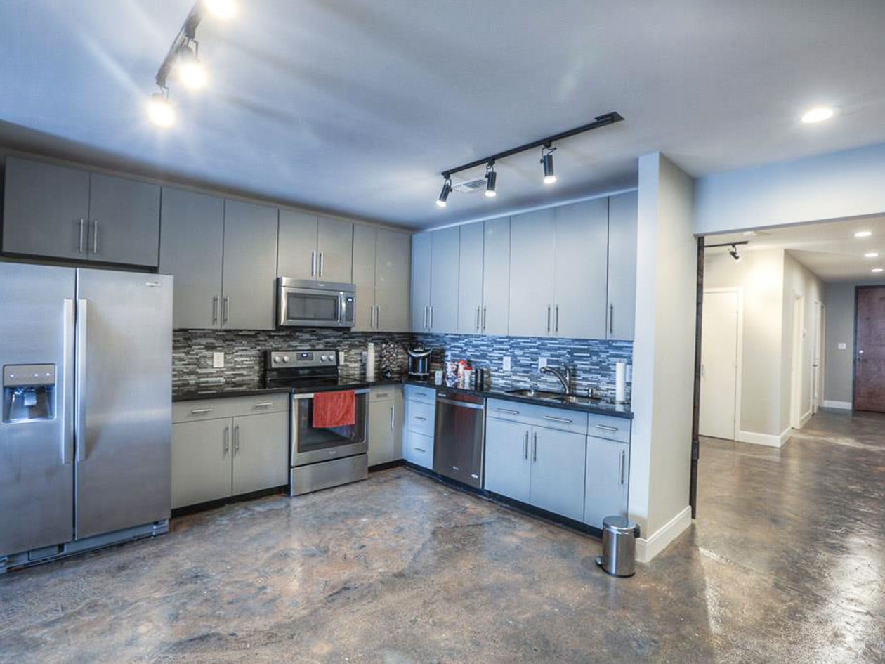 1601 West Webster Street, Unit 11 Houston, TX 77019 - Photo 13 of 26 a kitchen with stainless steel appliances granite countertop a refrigerator stove and sink