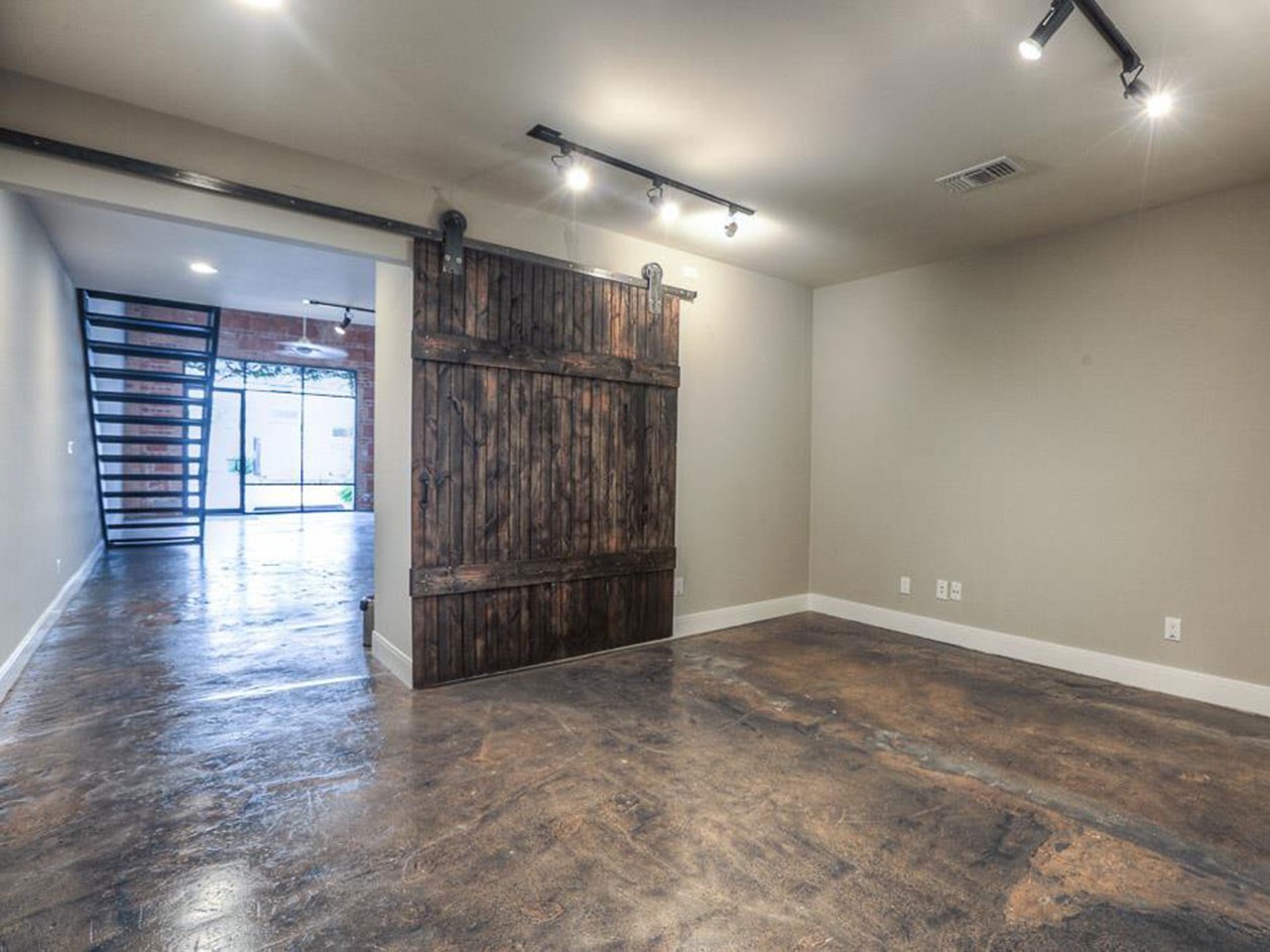 1601 West Webster Street, Unit 11 Houston, TX 77019 - Photo 16 of 26 an empty room with wooden floor and windows