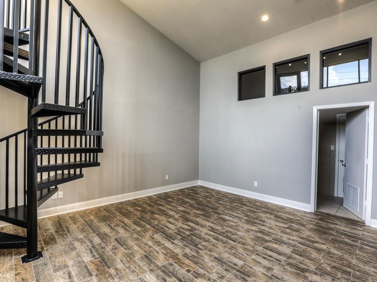 1601 West Webster Street, Unit 11 Houston, TX 77019 - Photo 17 of 26 a view of an empty room with wooden floor and a window