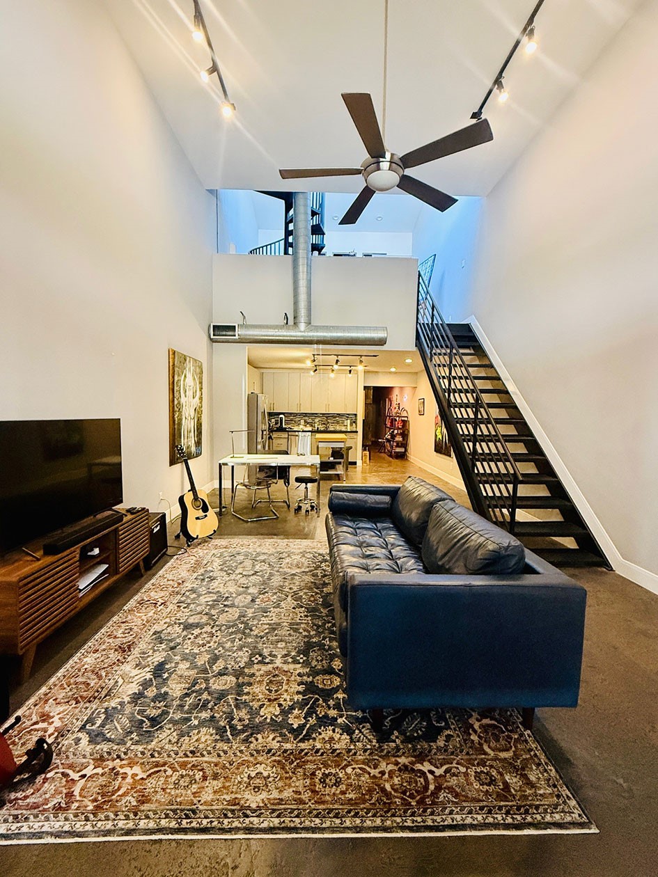 1601 West Webster Street, Unit 11 Houston, TX 77019 - Photo 23 of 26 a living room with furniture and a flat screen tv
