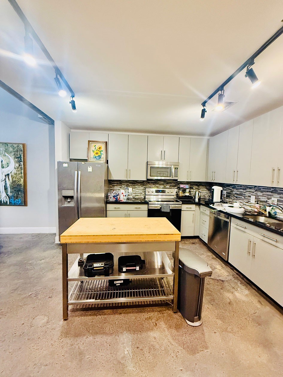 1601 West Webster Street, Unit 11 Houston, TX 77019 - Photo 25 of 26 a kitchen with a refrigerator a sink and white cabinets