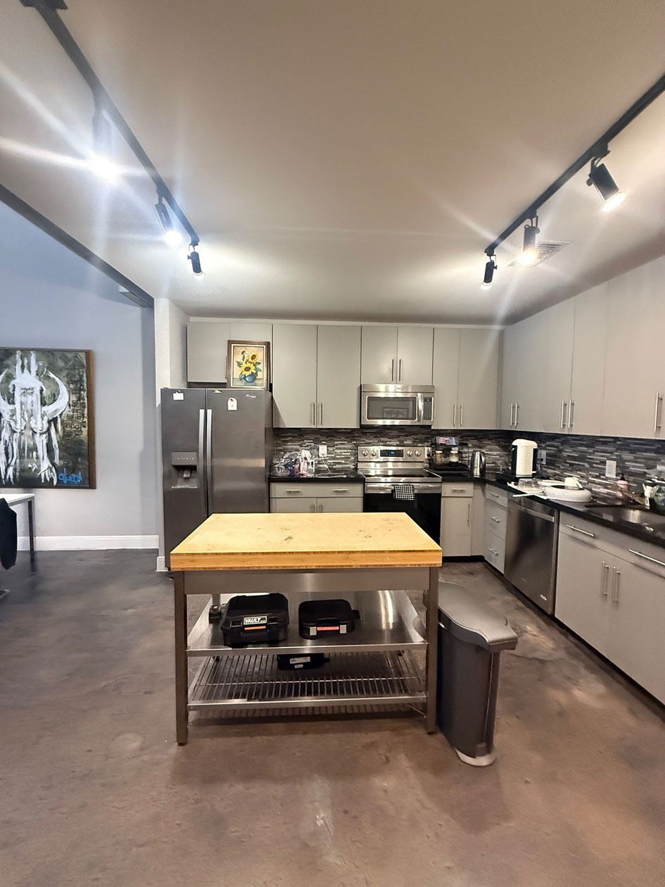 1601 West Webster Street, Unit 11 Houston, TX 77019 - Photo 26 of 26 a large kitchen with stainless steel appliances a stove a sink dishwasher and cabinets with wooden floor