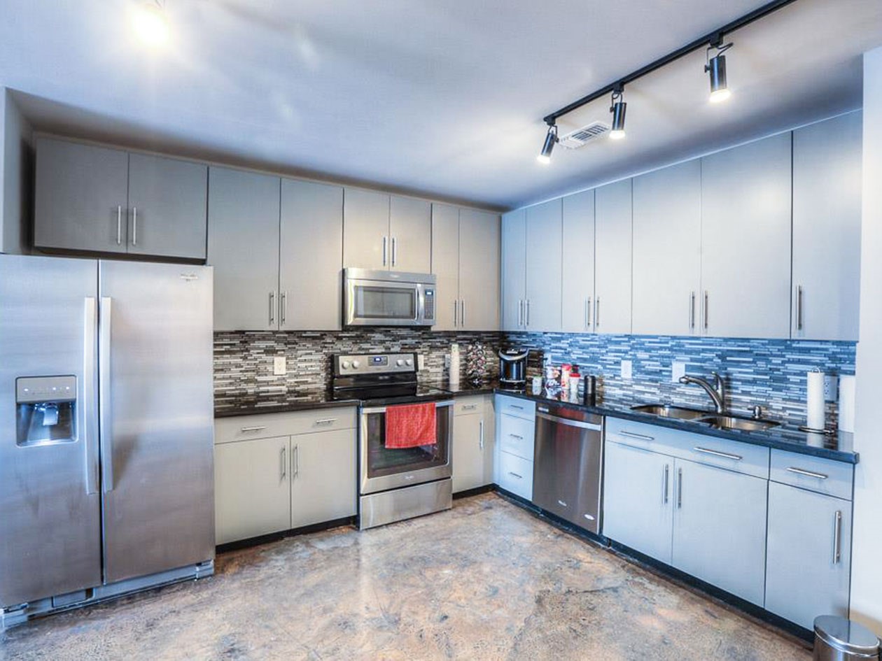 1601 West Webster Street, Unit 11 Houston, TX 77019 - Photo 8 of 26 a kitchen with stainless steel appliances granite countertop a stove sink and refrigerator
