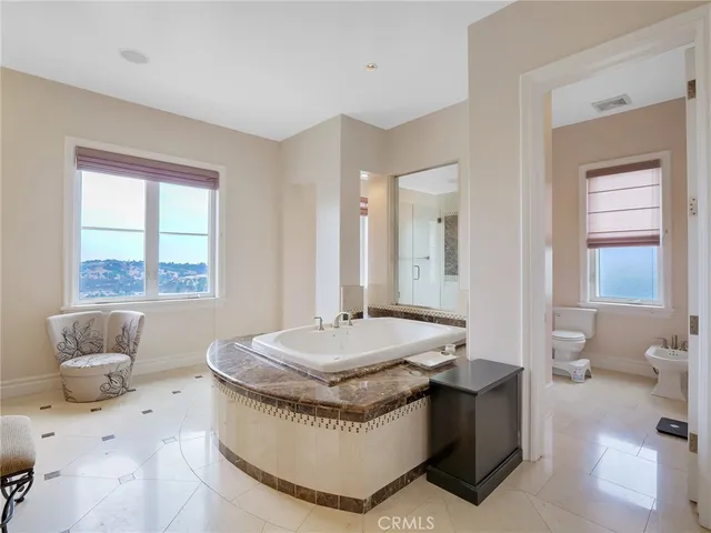 a spacious bedroom with a bed and a large window