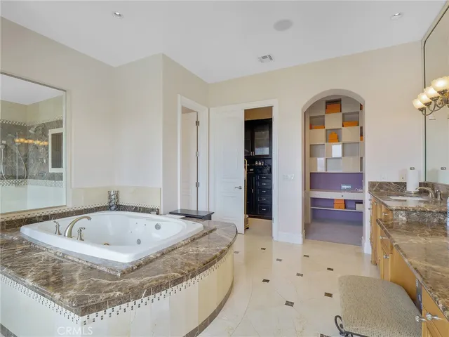 a spacious bedroom with a large bed and a couch