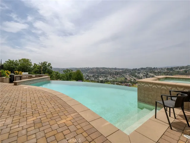 a view of a terrace with furniture and city view