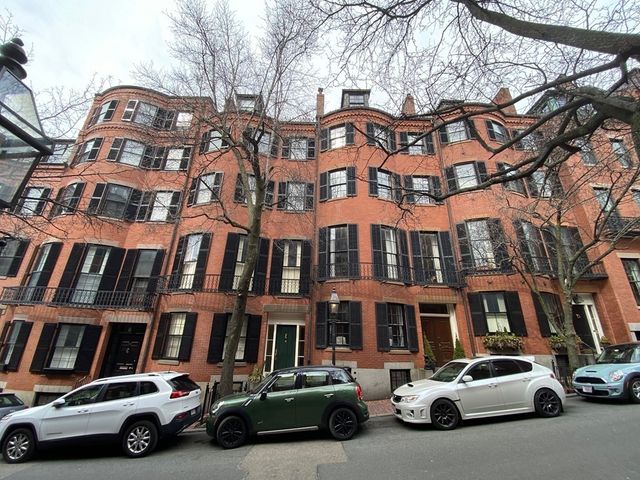 a car parked in front of a brick building