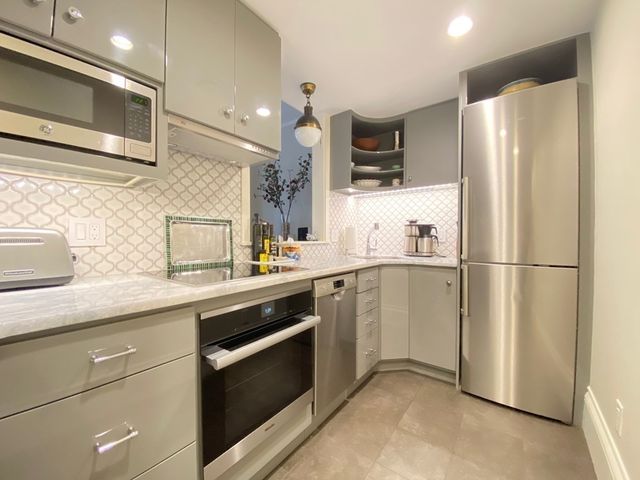 a kitchen with a refrigerator sink and microwave