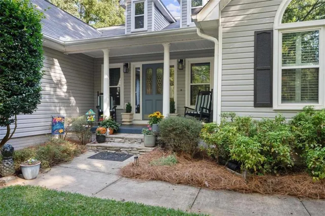 a front view of a house with yard and potted plants
