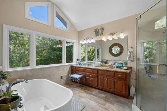 a large bathroom with a tub a sink and a mirror