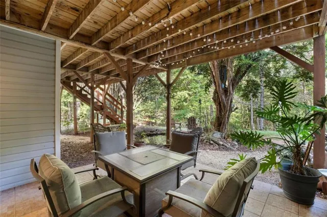 a view of a patio with table and chairs and potted plants