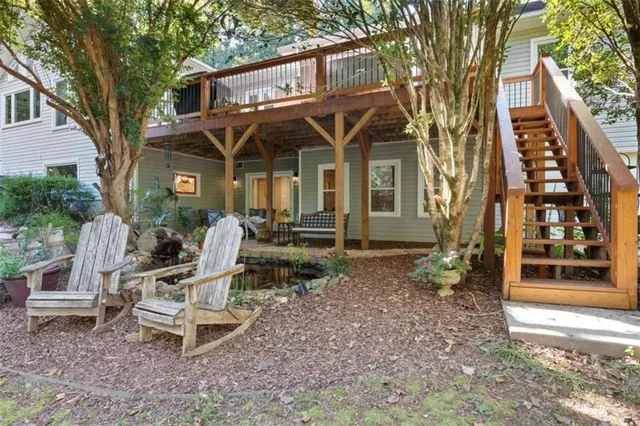 a view of a chair and tables in the backyard of the house