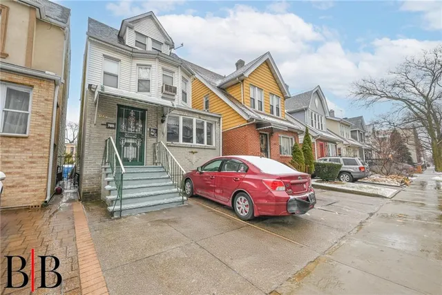 a red car parked in front of a building
