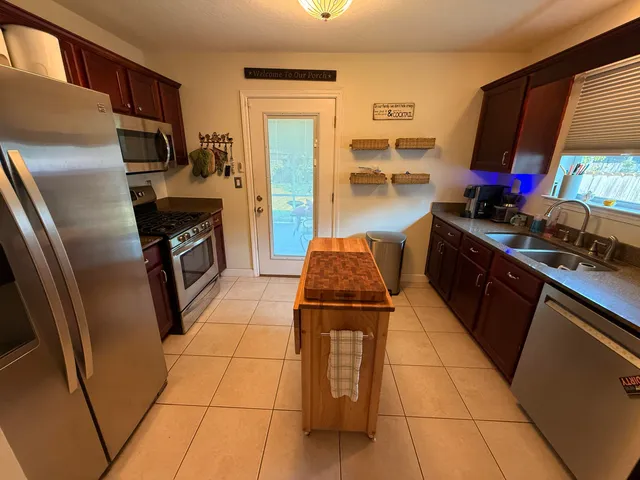 a kitchen with a refrigerator stove and microwave