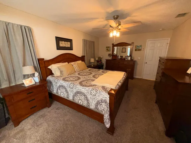 a bedroom with a bed and a dresser