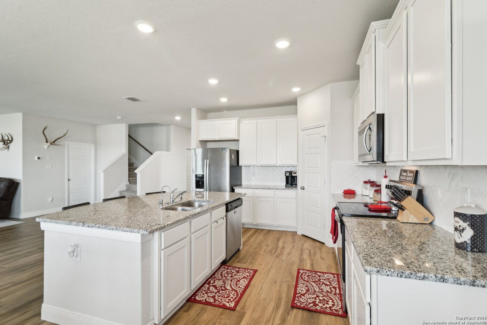402 Devnet Cibolo, TX 78108 - Photo 12 of 32 a kitchen that has a lot of cabinets and wooden floor