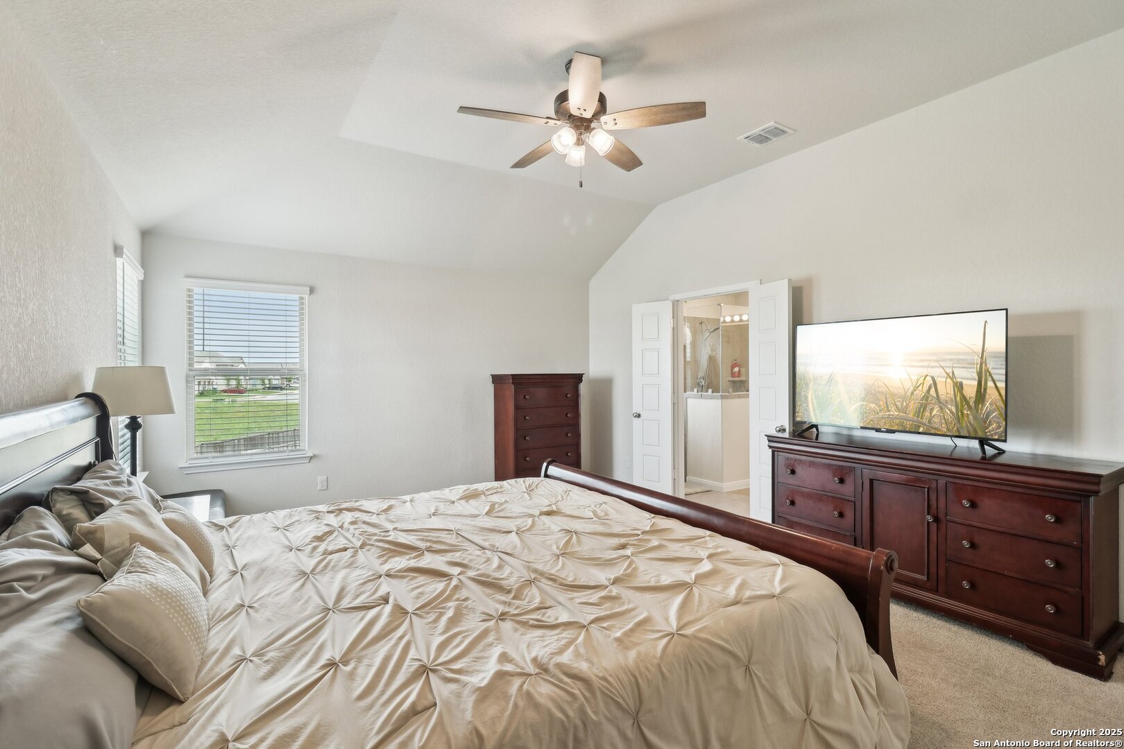 402 Devnet Cibolo, TX 78108 - Photo 22 of 32 a bedroom with a large bed and a flat tv screen on dresser