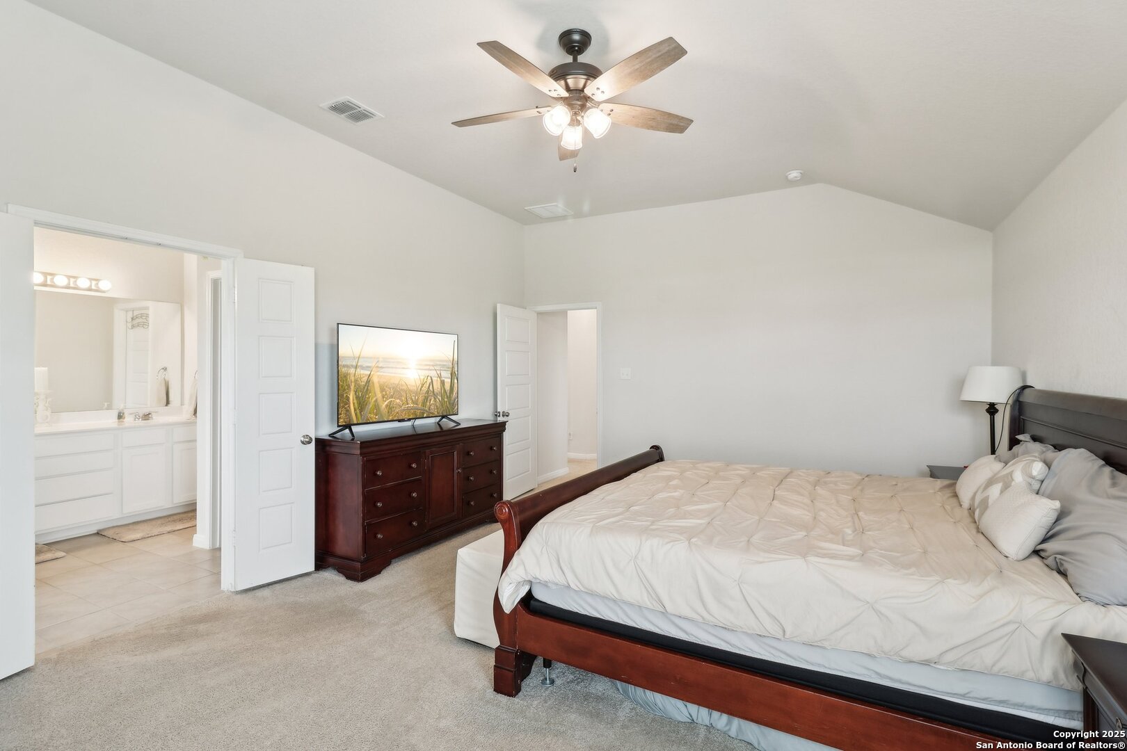 402 Devnet Cibolo, TX 78108 - Photo 23 of 32 a bedroom with a bed and a chandelier