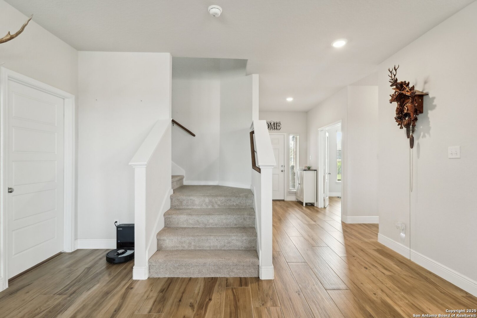 402 Devnet Cibolo, TX 78108 - Photo 3 of 32 a view of an entryway with wooden floor and stairs