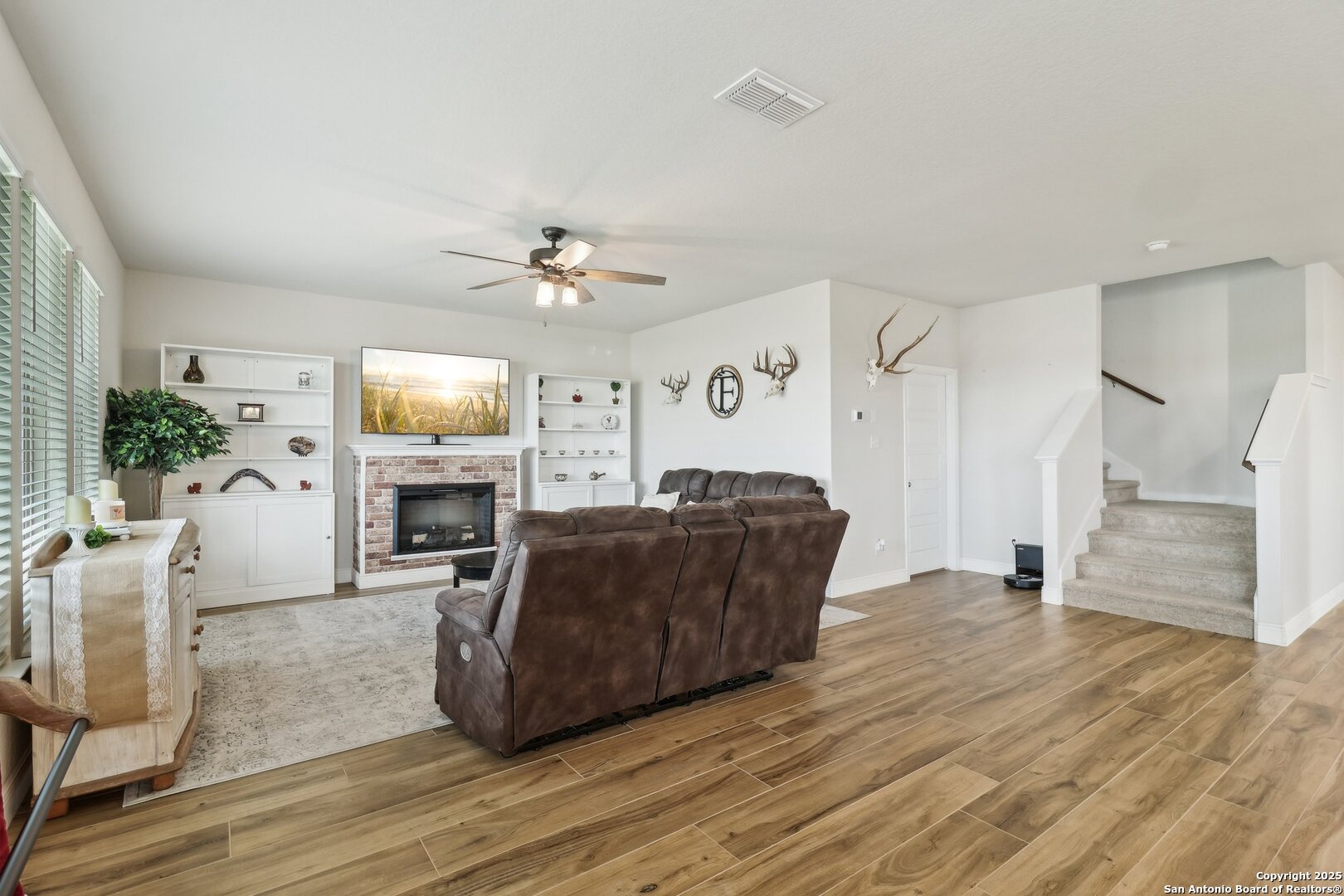 402 Devnet Cibolo, TX 78108 - Photo 5 of 32 a living room with furniture a fireplace and a flat screen tv
