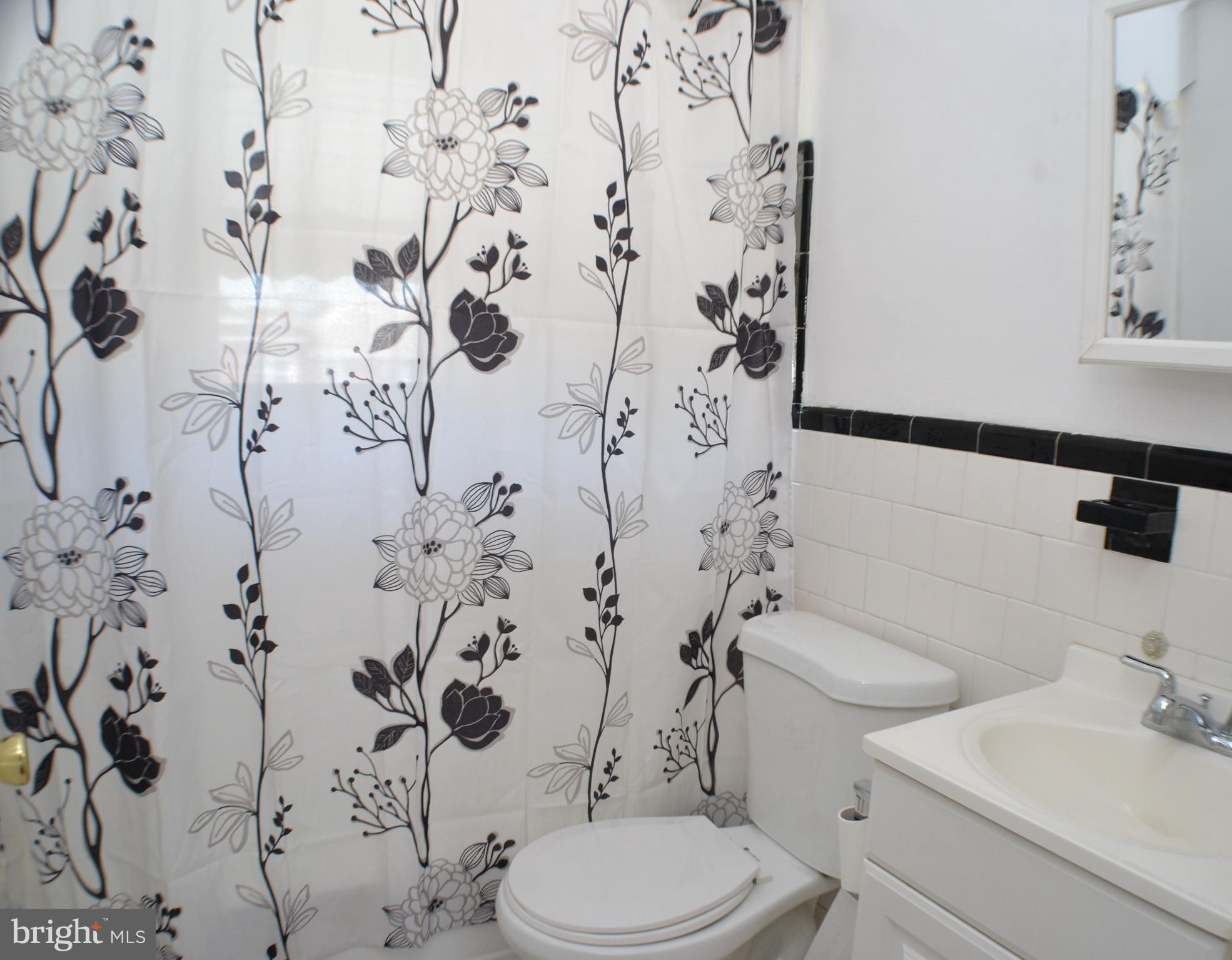 202 Kingston Road Middle River, MD 21220 - Photo 12 of 21 a white toilet sitting next to a shower curtain