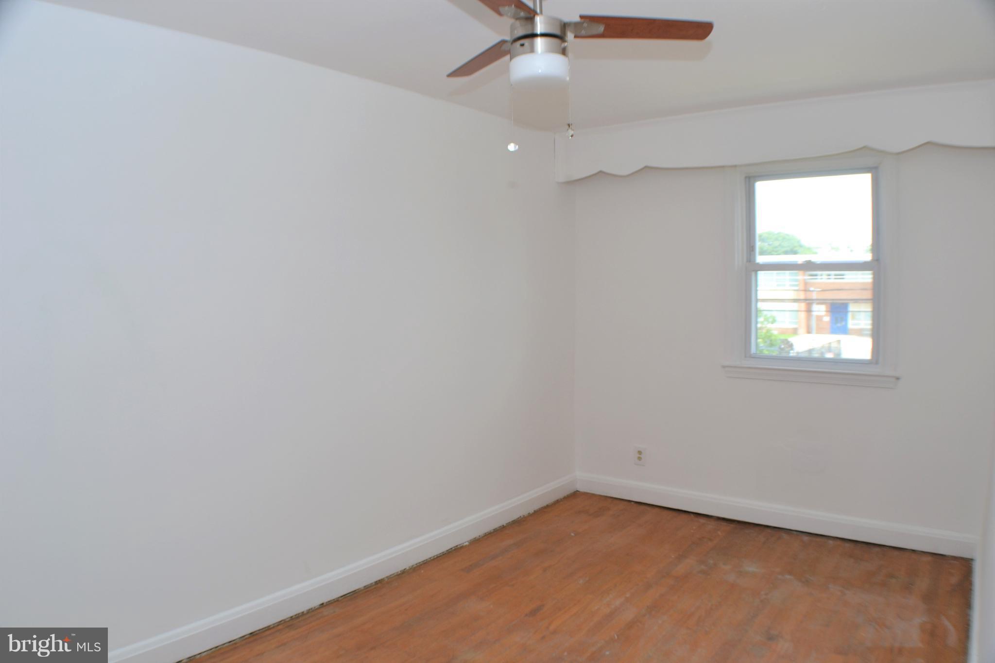 202 Kingston Road Middle River, MD 21220 - Photo 14 of 21 an empty room with a window and a fan
