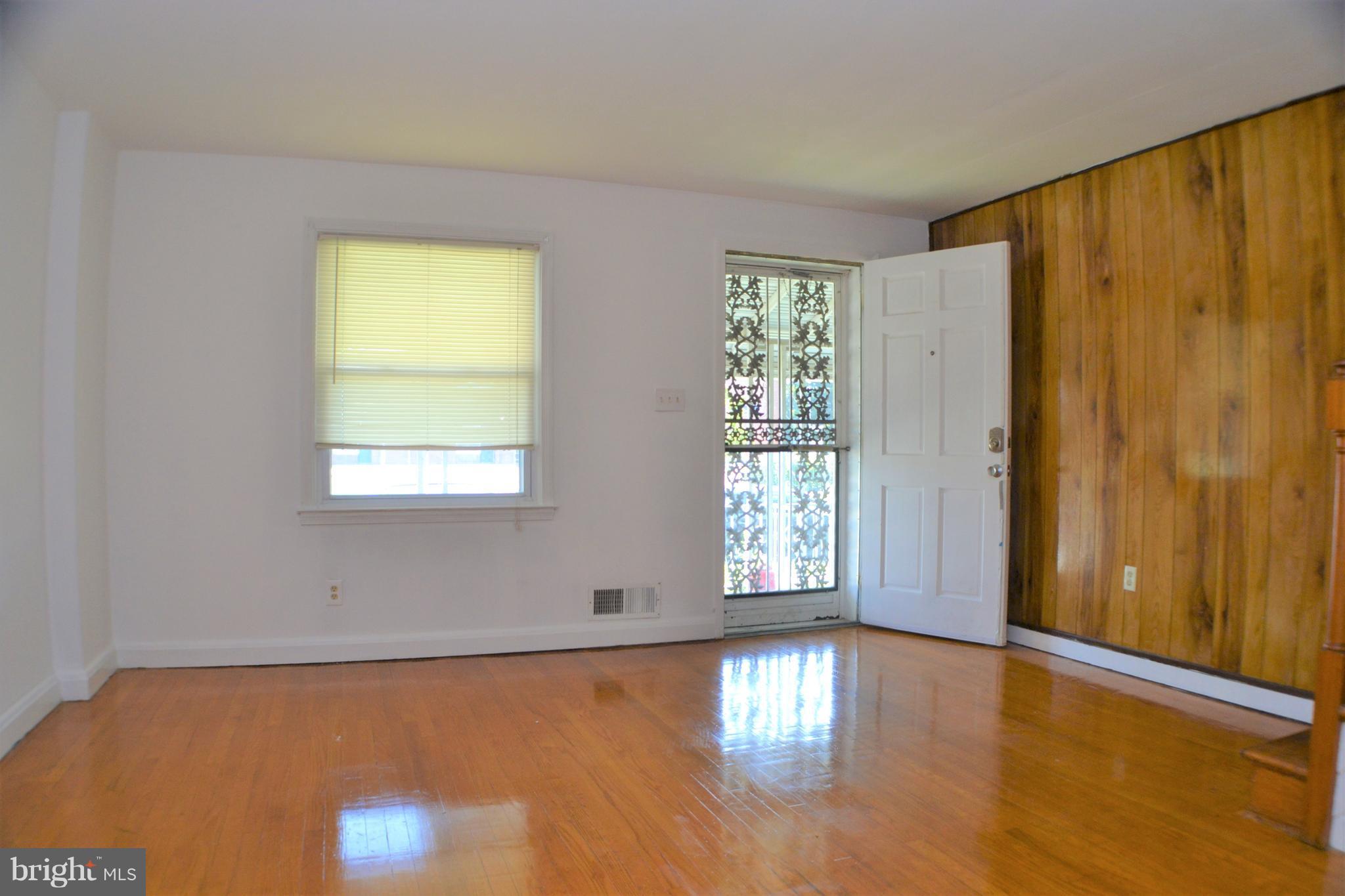202 Kingston Road Middle River, MD 21220 - Photo 5 of 21 an empty room with wooden floor and windows