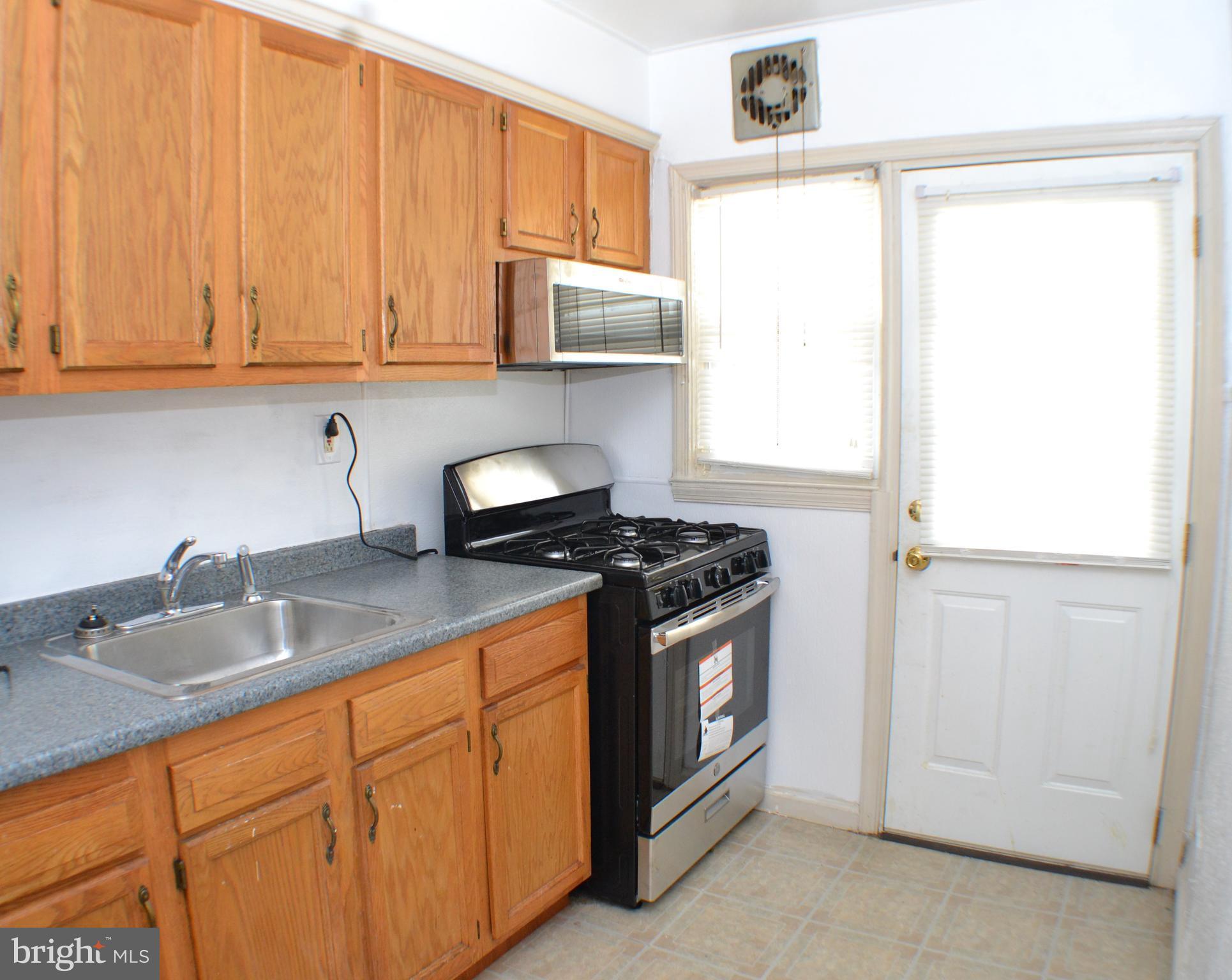 202 Kingston Road Middle River, MD 21220 - Photo 6 of 21 a kitchen with stainless steel appliances granite countertop white cabinets and a sink
