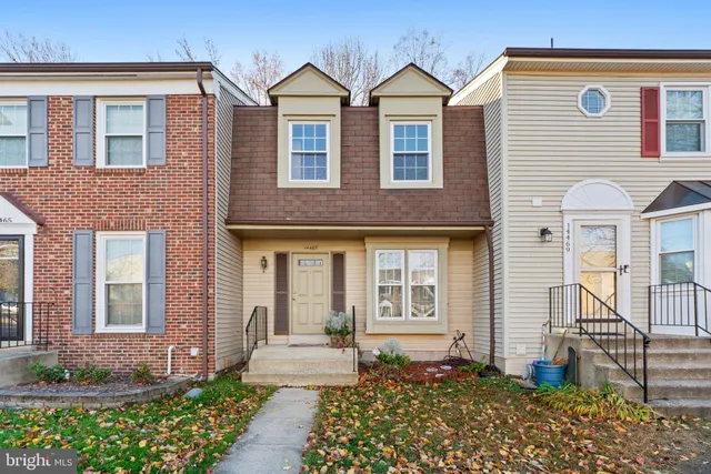 a front view of a house with a yard and outdoor seating