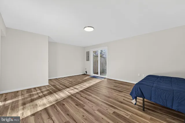 a view of a livingroom with wooden floor and furniture
