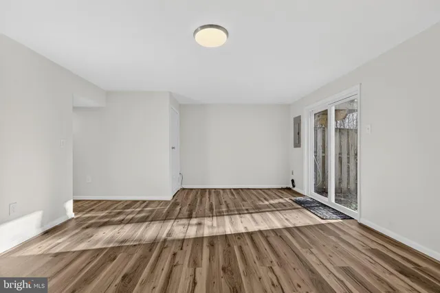 a view of a room with wooden floor and window
