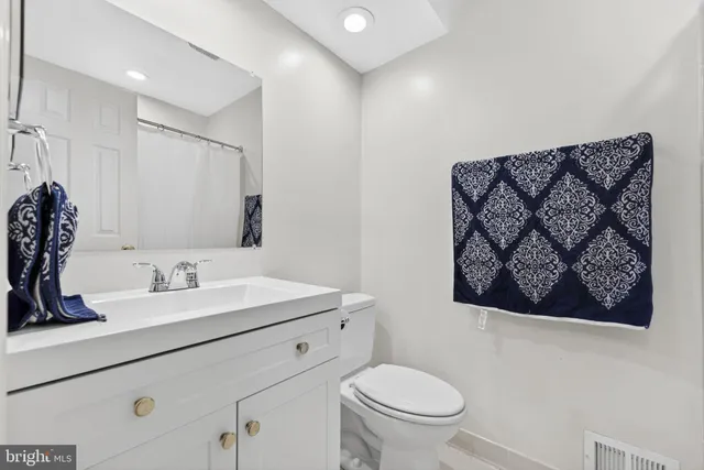 a bathroom with a toilet sink and mirror