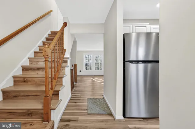 a view of a kitchen with wooden floor and entryway