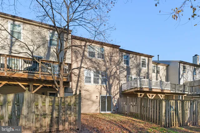 a view of a brick house with a small yard