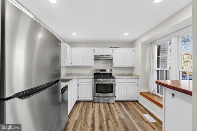 a kitchen with a sink stainless steel appliances and cabinets