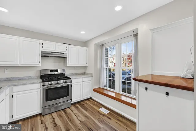 a kitchen with stainless steel appliances granite countertop a stove and a refrigerator