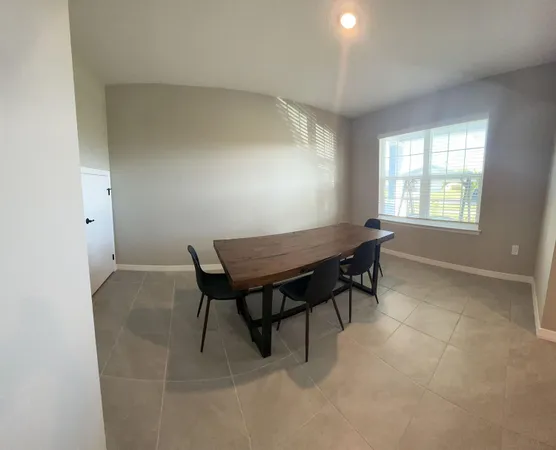 a view of a room with furniture and a window
