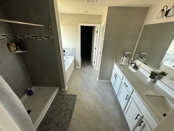 a bathroom with a double vanity sink and mirror