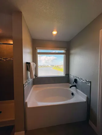 a white bath tub sitting in a bathroom