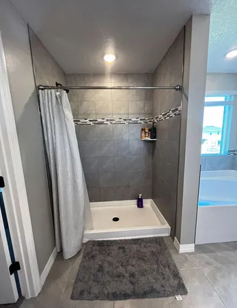 a bathroom with a sink a toilet a mirror and shower