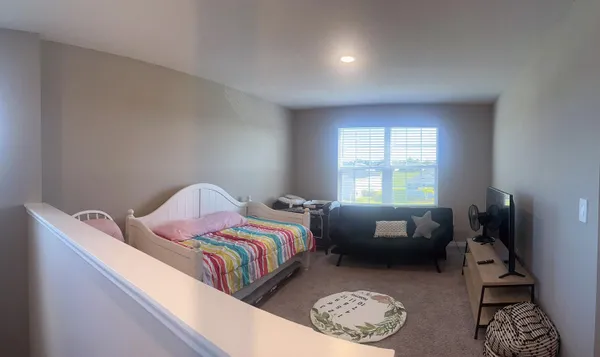 a bedroom with bed and a window