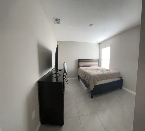 a bedroom with a bed and a dresser